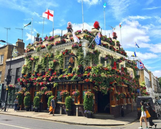 The flower-covered exterior of The Churchill Arms in Kensington 