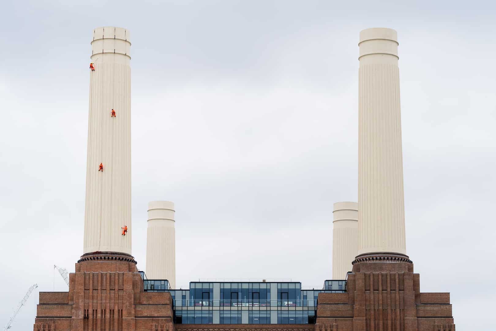 some people abseiling down the Battersea Power Station chimney to apply the last touches of paint to the chimney
