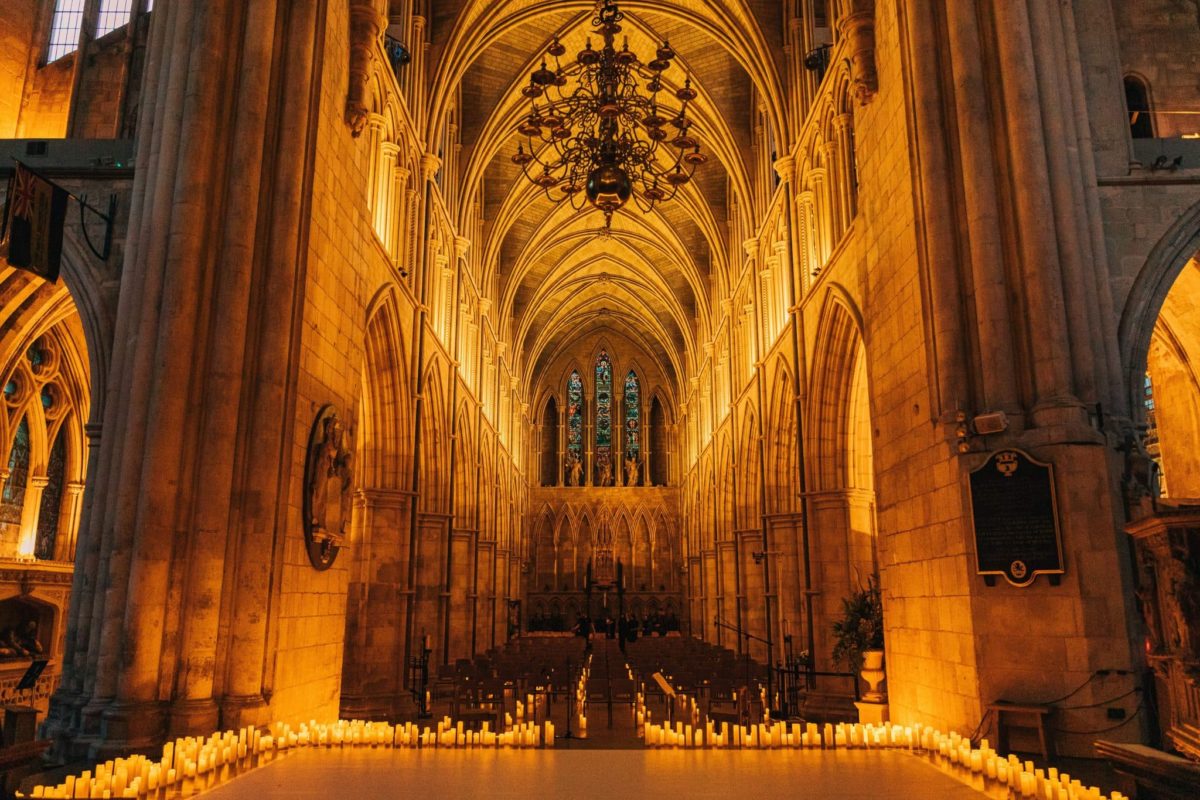 A wide shot of the interior of Southwark Cathedral lit only by the candles lining its walls a breathtaking experience in london to see