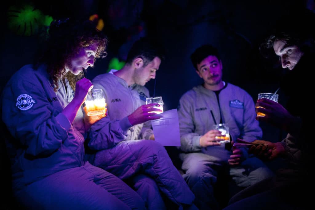 a group of friends drinking illuminated cocktails at Avora cocktail experience