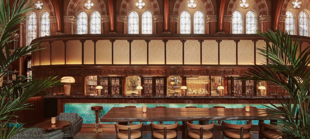 the gorgeous teal and bronze accented bar at booking office 1869, one of London's prettiest bars