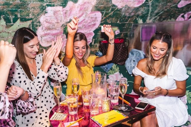 Some girls enjoying themselves at a bottomless disco brunch, one of the best hen do ideas in London