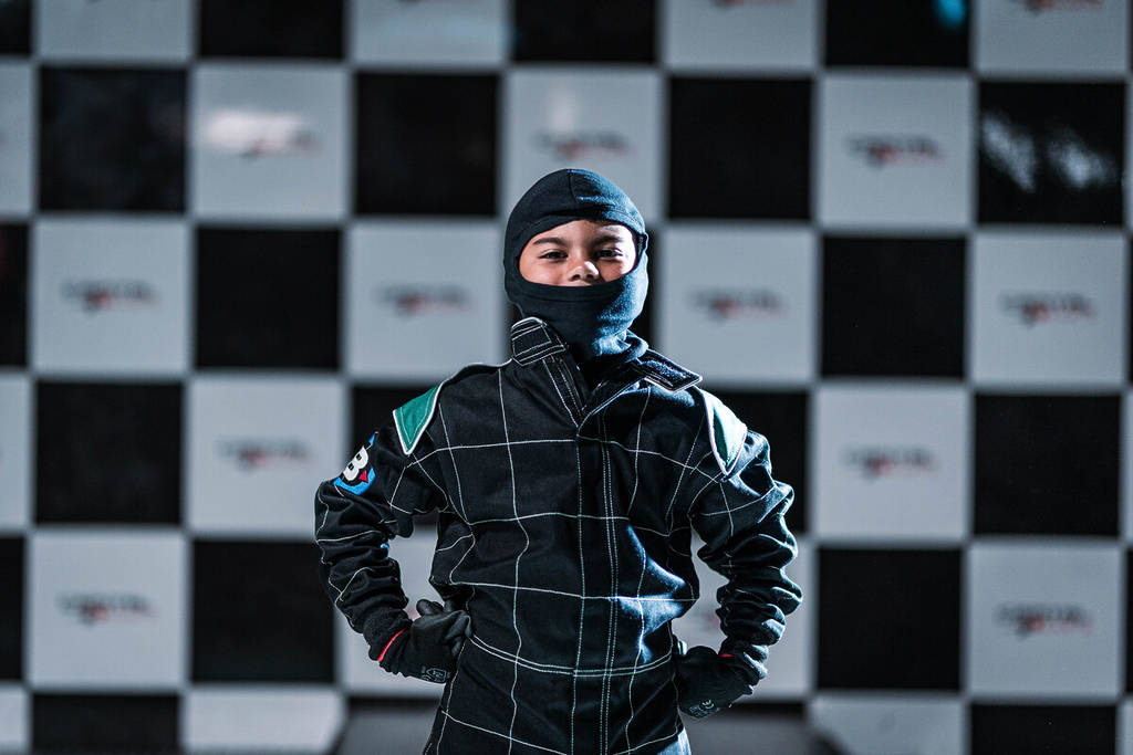 a kid dressed up in go-kart racing gear