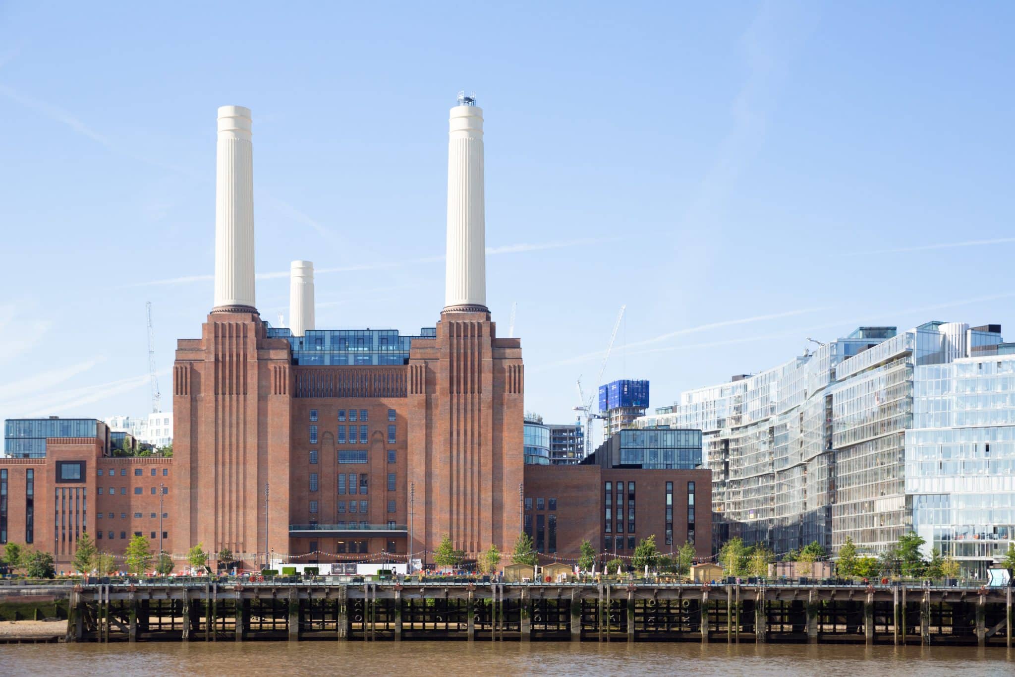 A photo of Battersea Power Station's exterior, with the LIFT faintly visible at the top of one of the chimneys