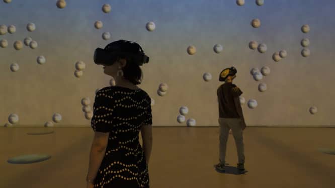 Visitors wearing VR goggles in a large exhibition room at Dali Cybernetics, one of the best VR experiences in London