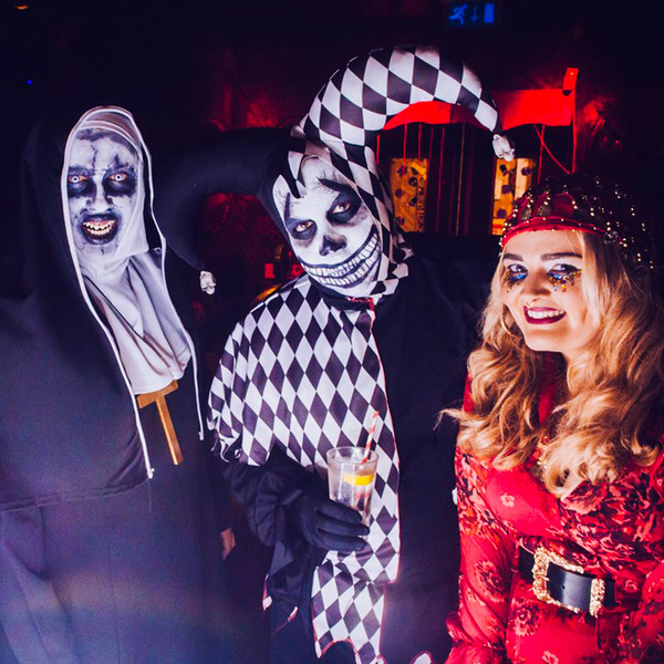 Three people dressed up as Halloween and enjoying themselves at the Halloween Dark Nightmare Party 