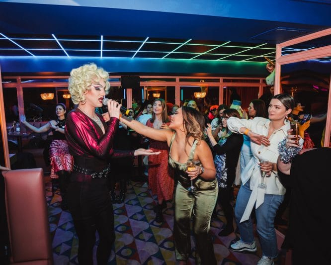A drag queen performing to some audience members at Salsa! Temple, one of the best birthday ideas in London