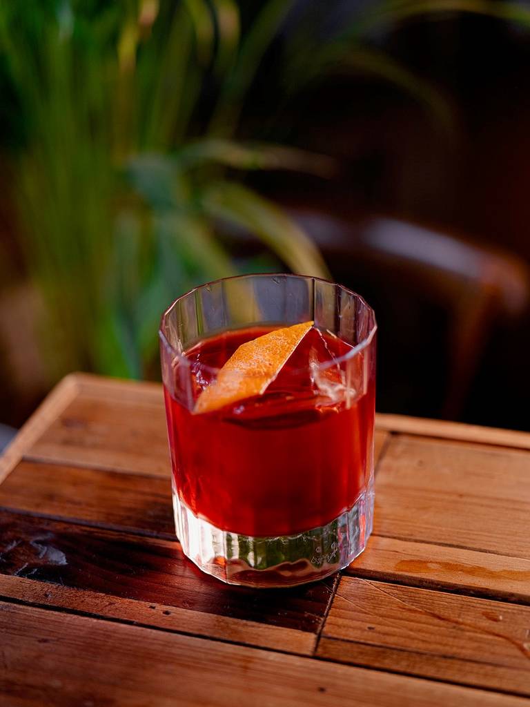 a negroni from Fern, set atop a wooden table