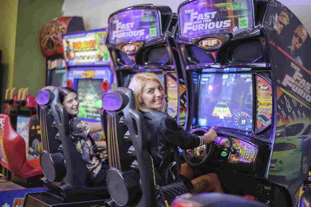 Someone enjoying themselves playing a game at one of the best arcades in London