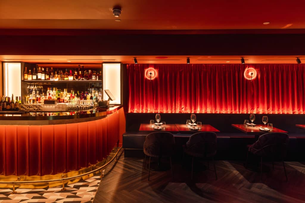 the red curtained interiors of gaucho's new restaurant in Covent Garden, with the bar nestled into the corner