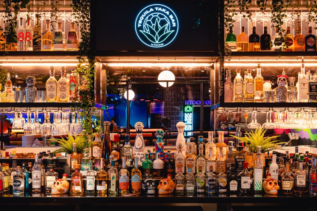 the tequila bar at toca social with a bevy of tequila bottles jostling for space on the bar