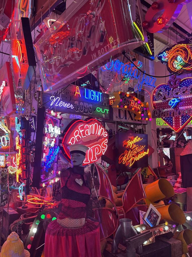 neon signs fill the space at god's own junkyard