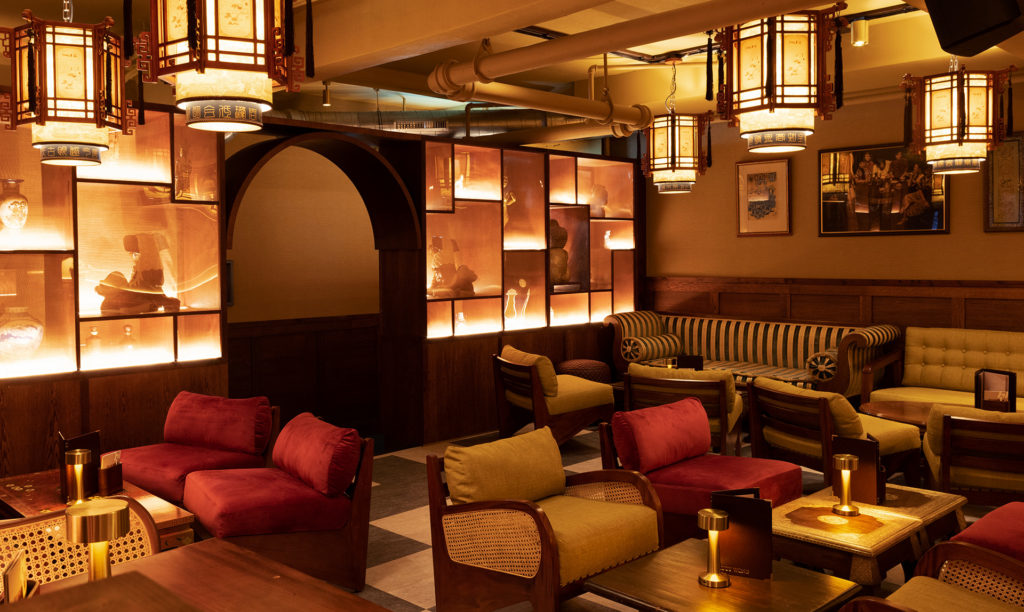 the softly-lit interiors of Lucy Wong, with plush seating in a homely-looking setting