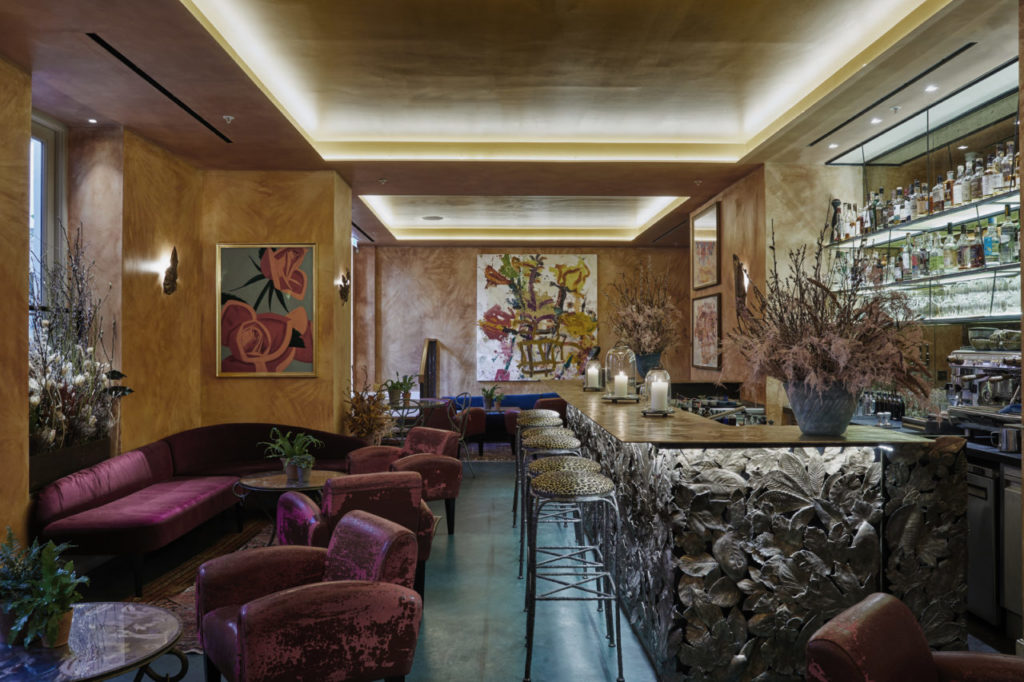 the la goccia bar, with a gorgeous flower printed bar to the right, and plush seating scattered around