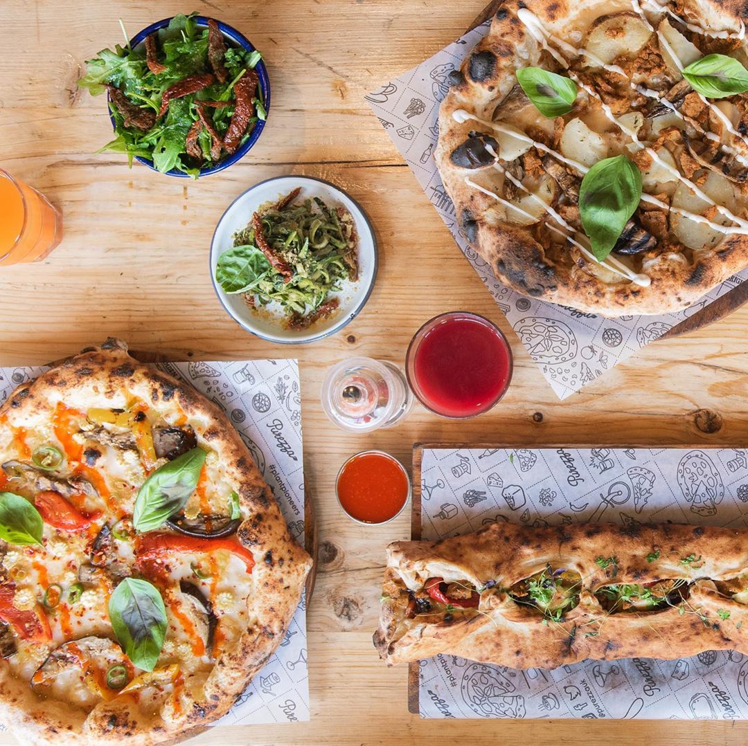 A delicious spread of pizzas and salads at Purezza in Camden, one of the best vegan restaurants in London 