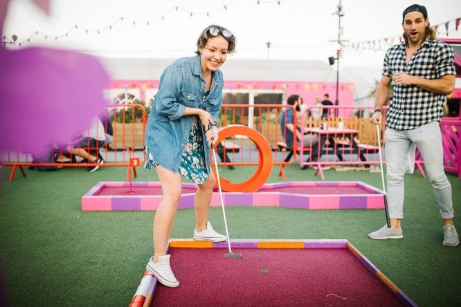 A woman playing some crazy golf at Roof East in Stratford