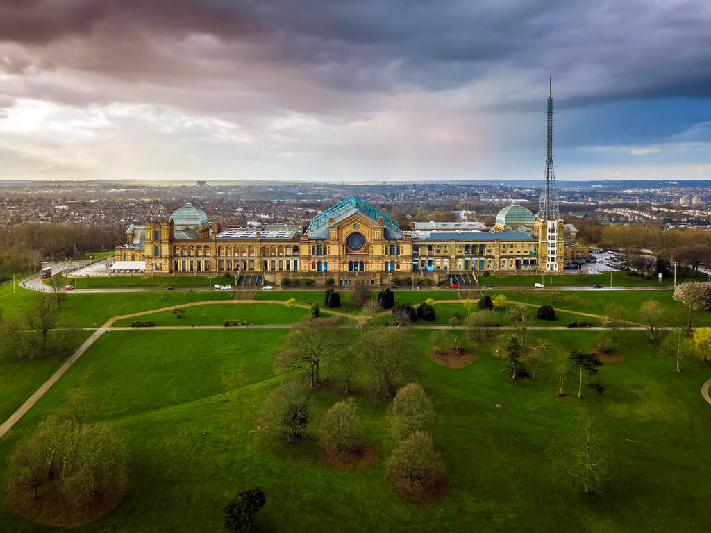 Aerial panromaic view of Alexandra Palace in Alexandra Park with dramatic clouds behind