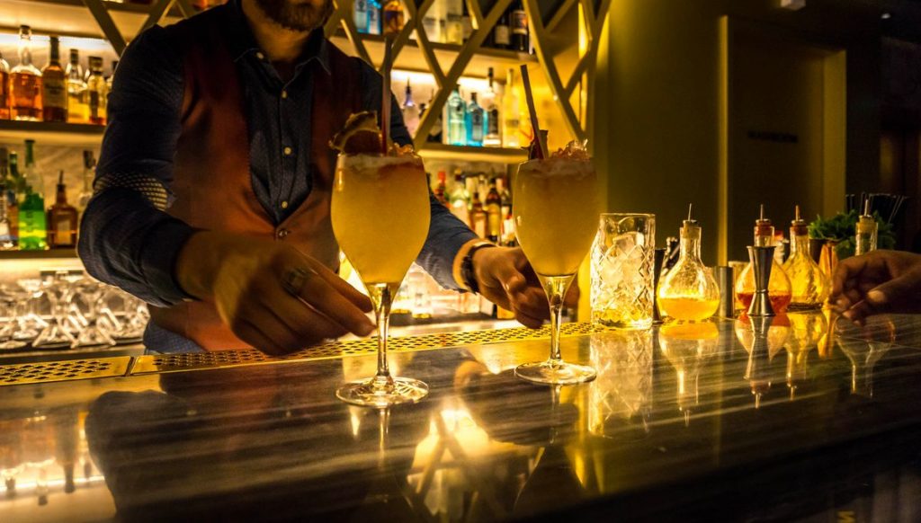 A picture of a man mixing cocktails at one of the best secret bars in London