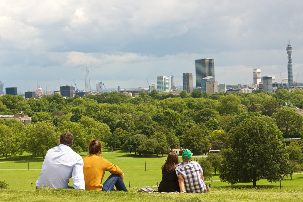 Two couples surveying the view from Primrose Hill – one of the best things to do in London