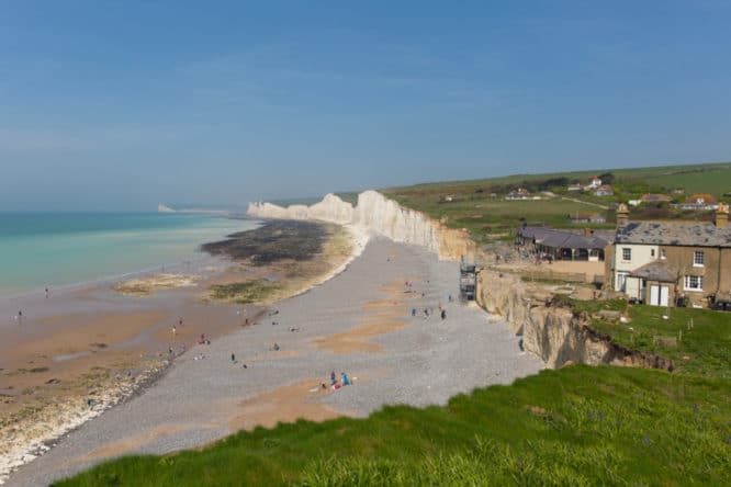 The white chalk cliffs and shingle beach at Birling Gap in East Sussex
