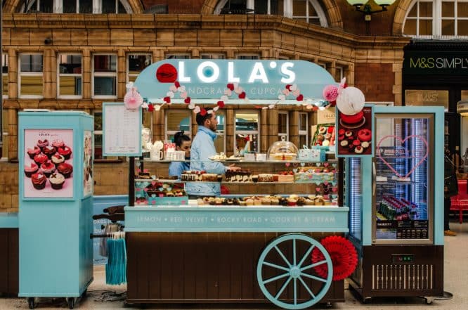A cart selling some delicious cakes from Lola's Cupcakes, one of the best cake shops in London