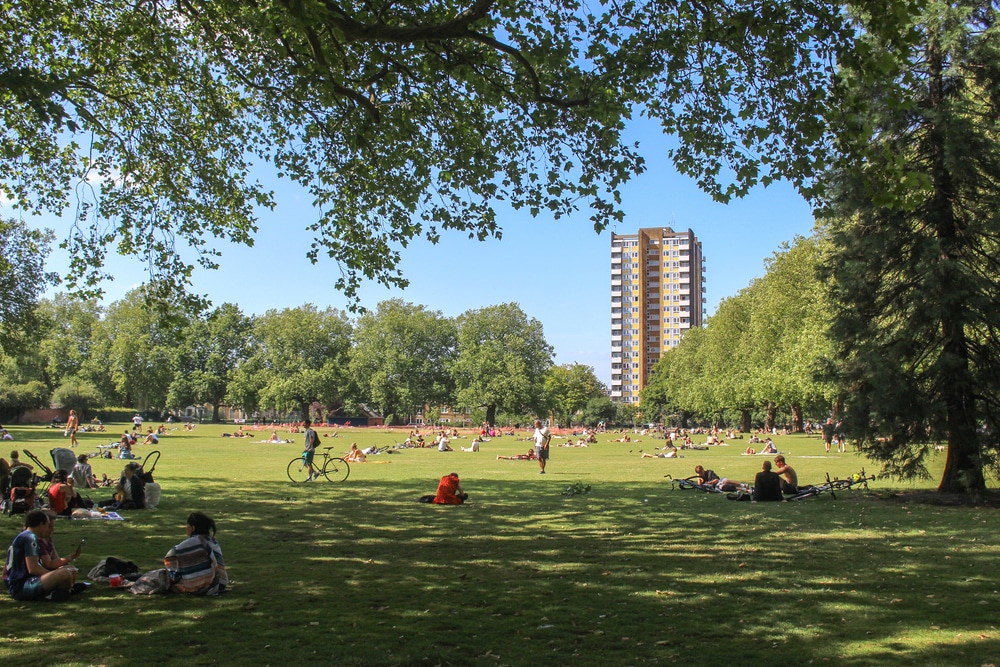 People enjoying the sunshine in the landscaped gardens of London Fields