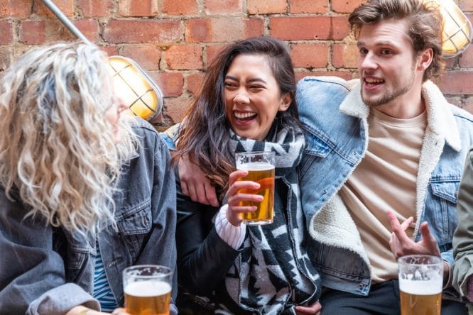 People enjoying some pints on a West End pub crawl in London