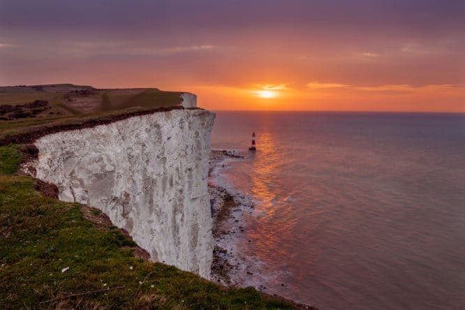 The sun setting over the waters of the English Channel by Beachy Head in Eastbourne
