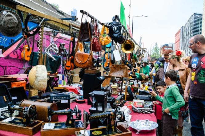 People perusing various different trinkets at Brick Lane Market in East London