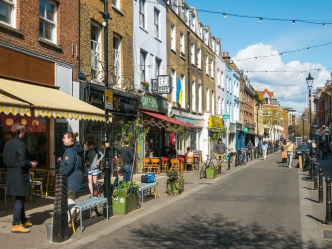 The pedestrianised street of Exmouth Market in the sun, one of the best things to do in Angel, Islington