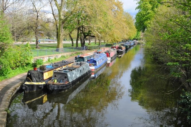 The canal and houseboats basked in sunshine by Victoria Park in London