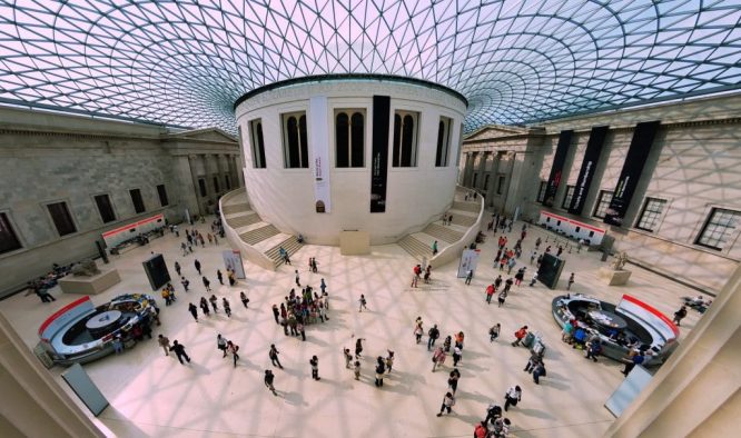 People wandering around the interior of the British Museum 