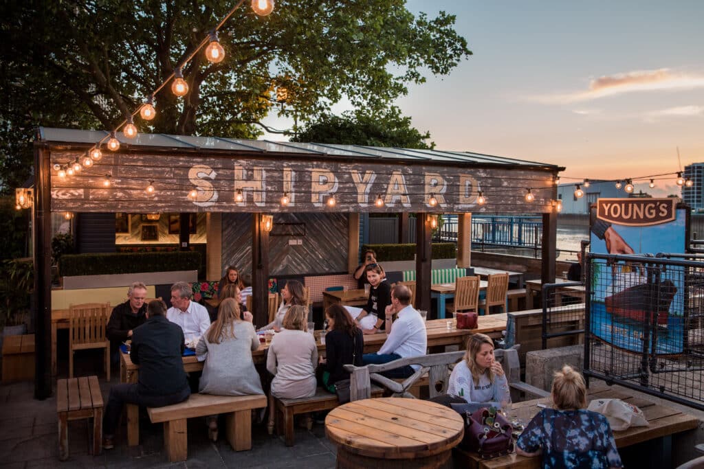 people enjoying a balmy evening in the shipyard beer garden at the ship pub