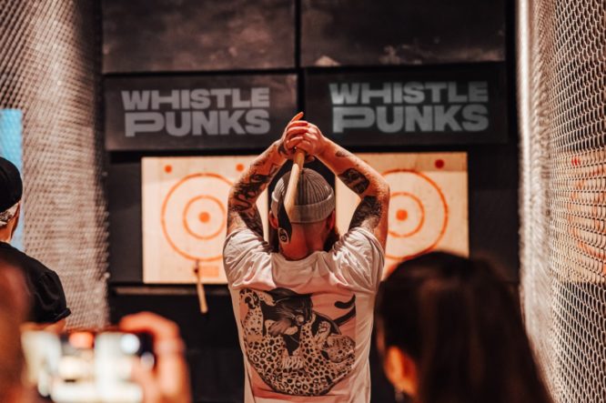 someone preparing to throw an axe at a target at whistle punks
