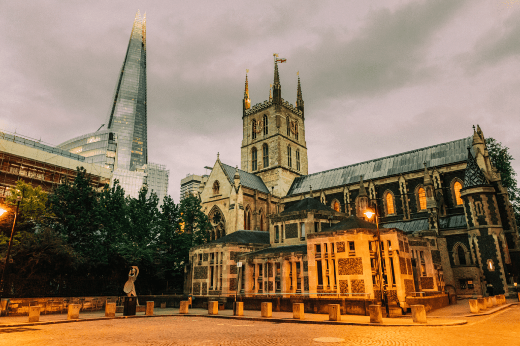 The exterior of Southwark Cathedral lit up by warm street light.