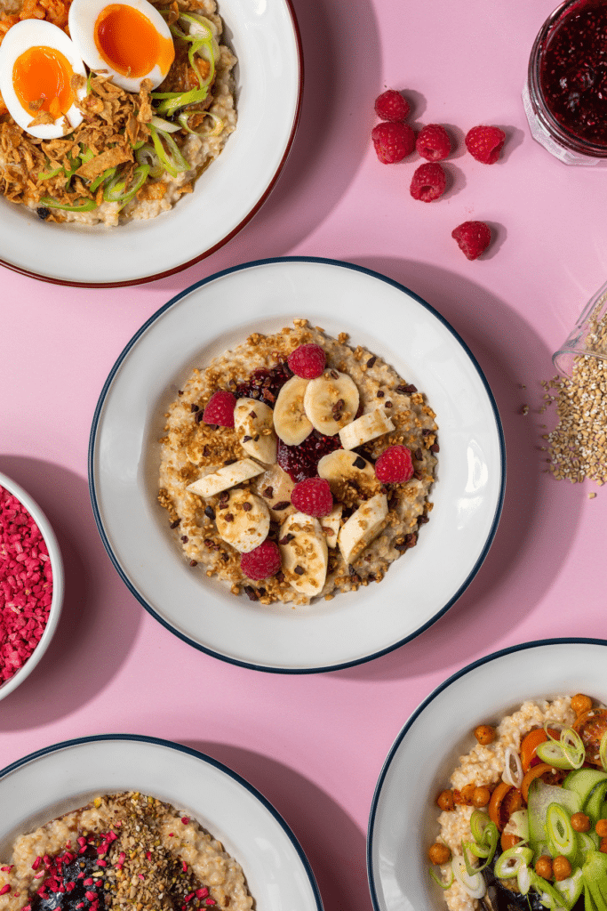 an assortment of sweet oat bowls shot from above, presented on a pink table
